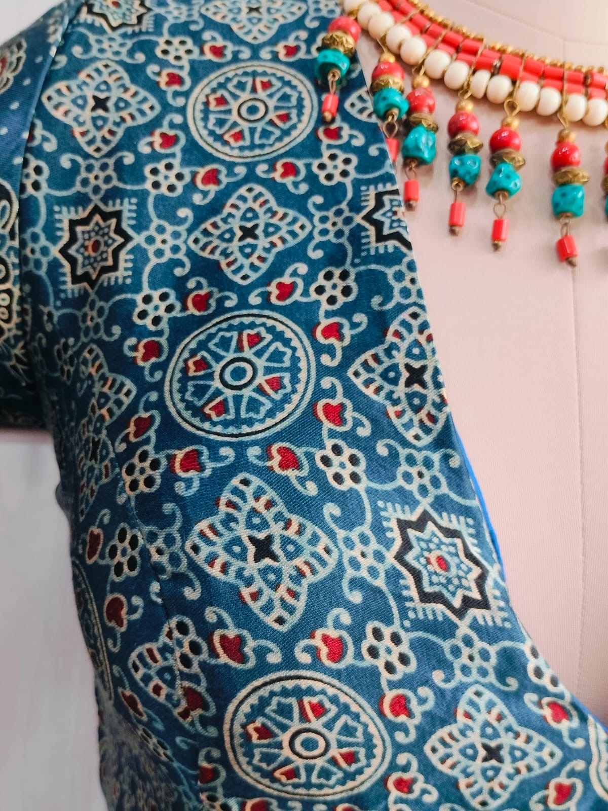 Close-up of geometric and floral print on modal blouse