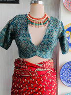 Back view of teal printed blouse with elongated keyhole