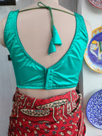 Back view of turquoise satin blouse with tassel tie-up cords