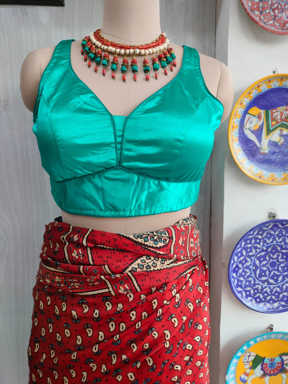 Front view of turquoise satin padded blouse