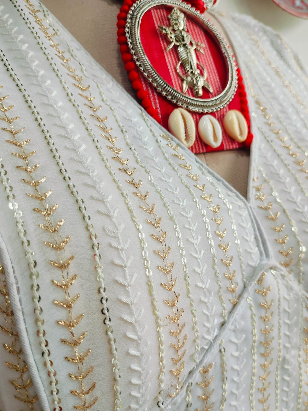 Detail of V-neck and vertical sequin embellishment
