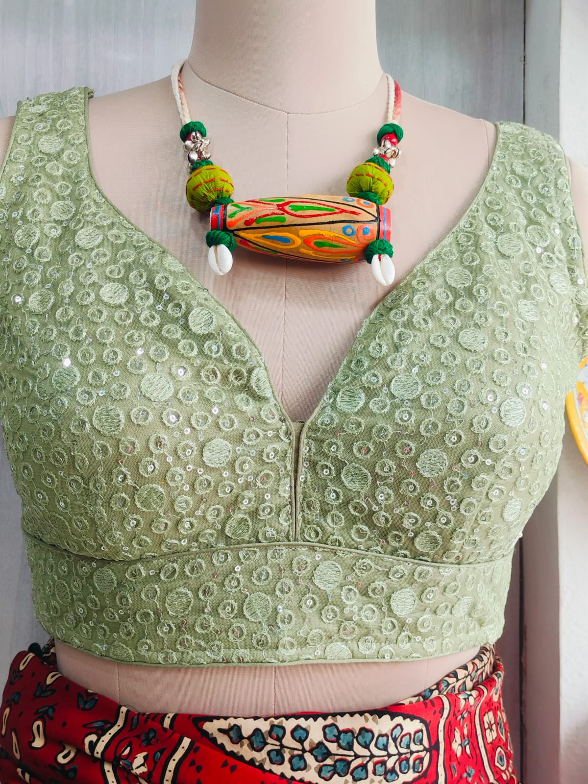 Front detail showing sequin and circular embroidery motifs