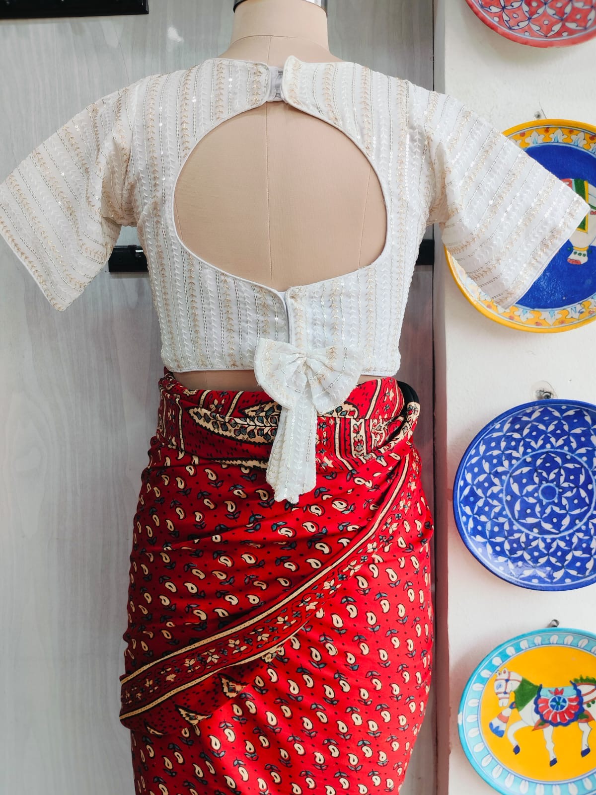 Back view of ivory blouse with rounded cut-out and bow