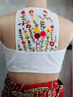 Back view of white cotton blouse with colourful floral hand embroidery