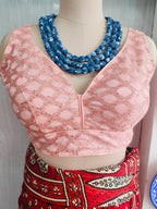 Close front view showing the V-neck and sequin lattice pattern