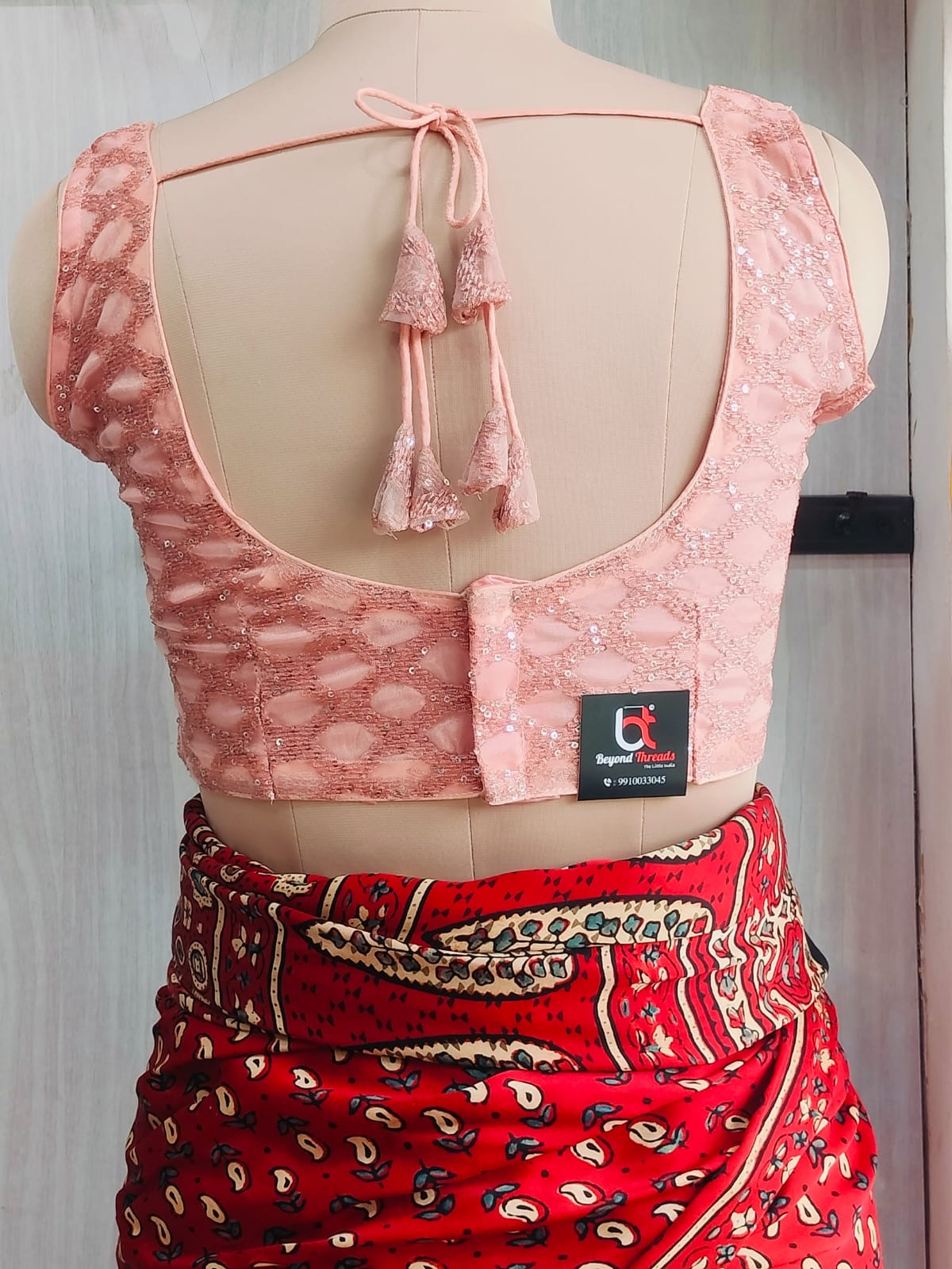 Back view of blush pink blouse with tassel tie-up cords