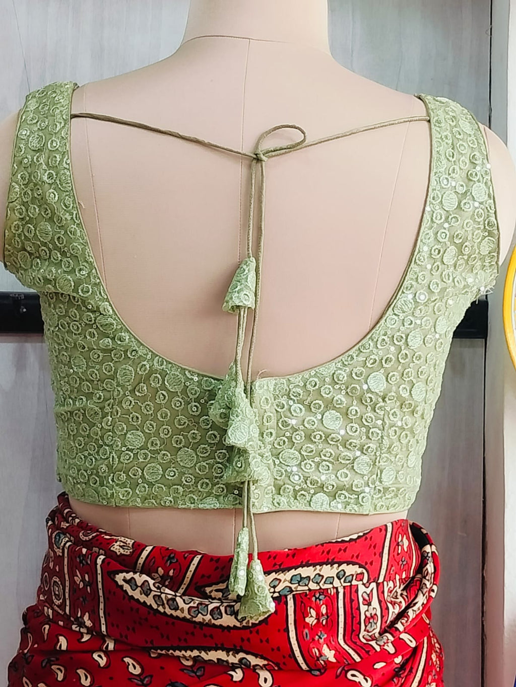 Back detail of green blouse with matching tassel tie-up cords