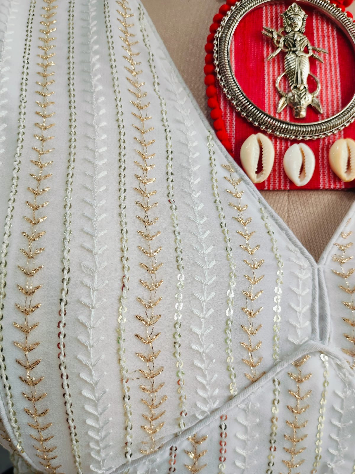 Close-up of gold-tone leaf embroidery and sequins