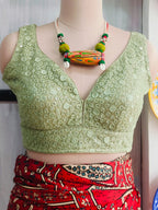 Closer front view of pista green V-neck party wear blouse